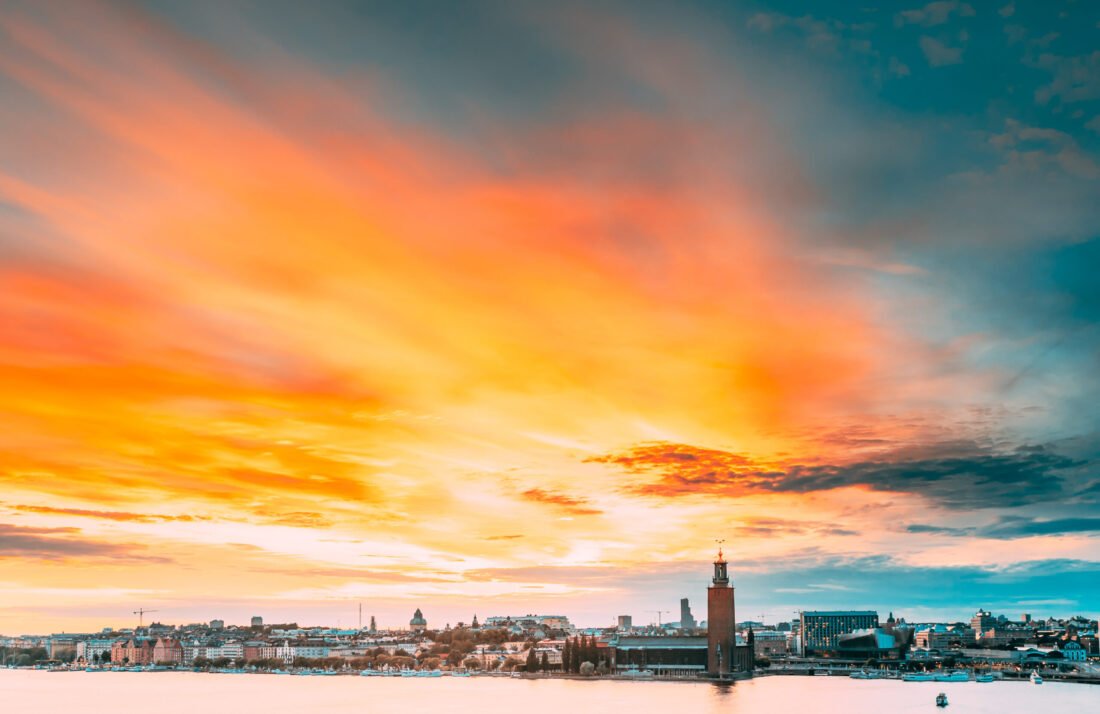 Stockholm, Sweden. Scenic Famous View Of Skyline Cityscape Embankment At Summer Sunset Sunrise. Famous Popular Destination Place Stockholm City Hall Stadshuset On Eastern Tip Of Kungsholmen Island.