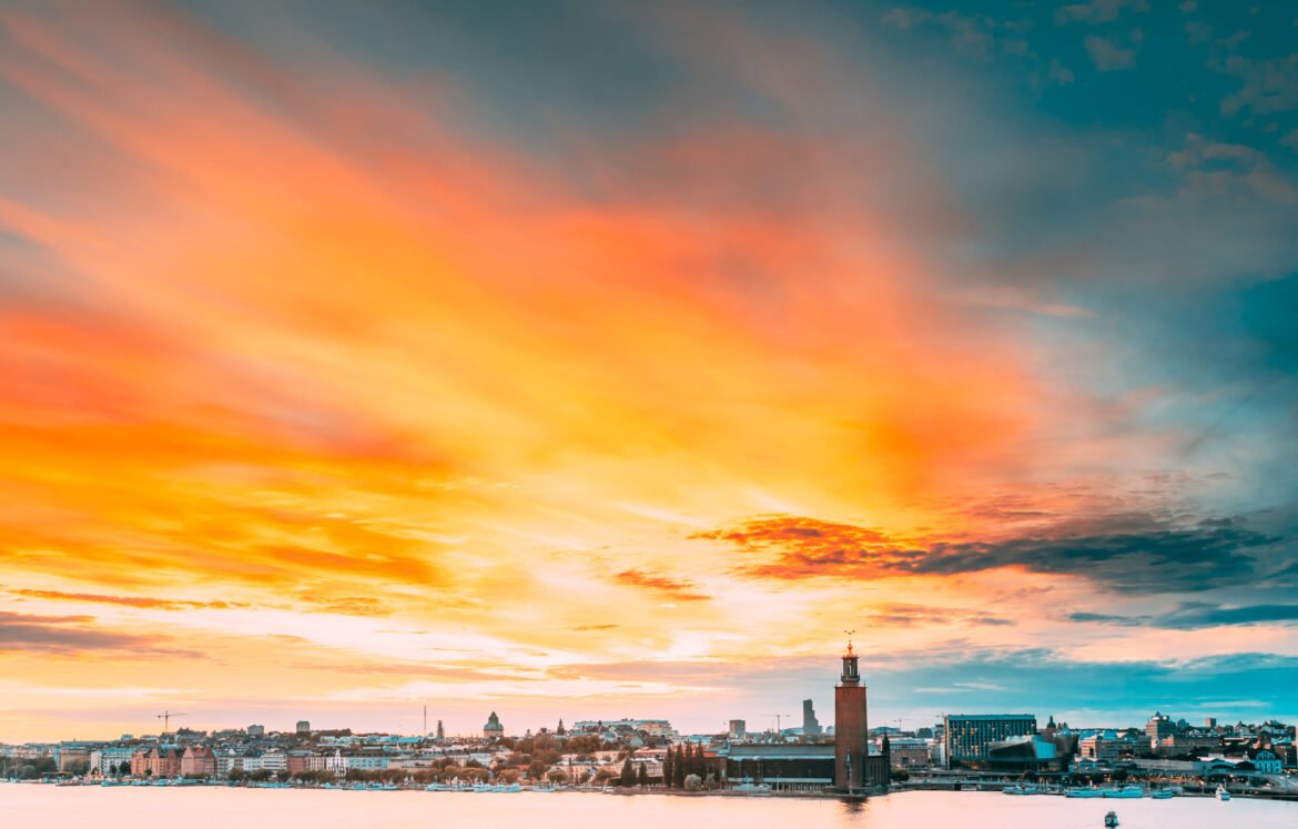 Stockholm, Sweden. Scenic Famous View Of Skyline Cityscape Embankment At Summer Sunset Sunrise. Famous Popular Destination Place Stockholm City Hall Stadshuset On Eastern Tip Of Kungsholmen Island.