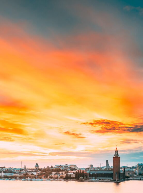 Stockholm, Sweden. Scenic Famous View Of Skyline Cityscape Embankment At Summer Sunset Sunrise. Famous Popular Destination Place Stockholm City Hall Stadshuset On Eastern Tip Of Kungsholmen Island.