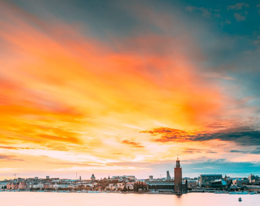 Stockholm, Sweden. Scenic Famous View Of Skyline Cityscape Embankment At Summer Sunset Sunrise. Famous Popular Destination Place Stockholm City Hall Stadshuset On Eastern Tip Of Kungsholmen Island.