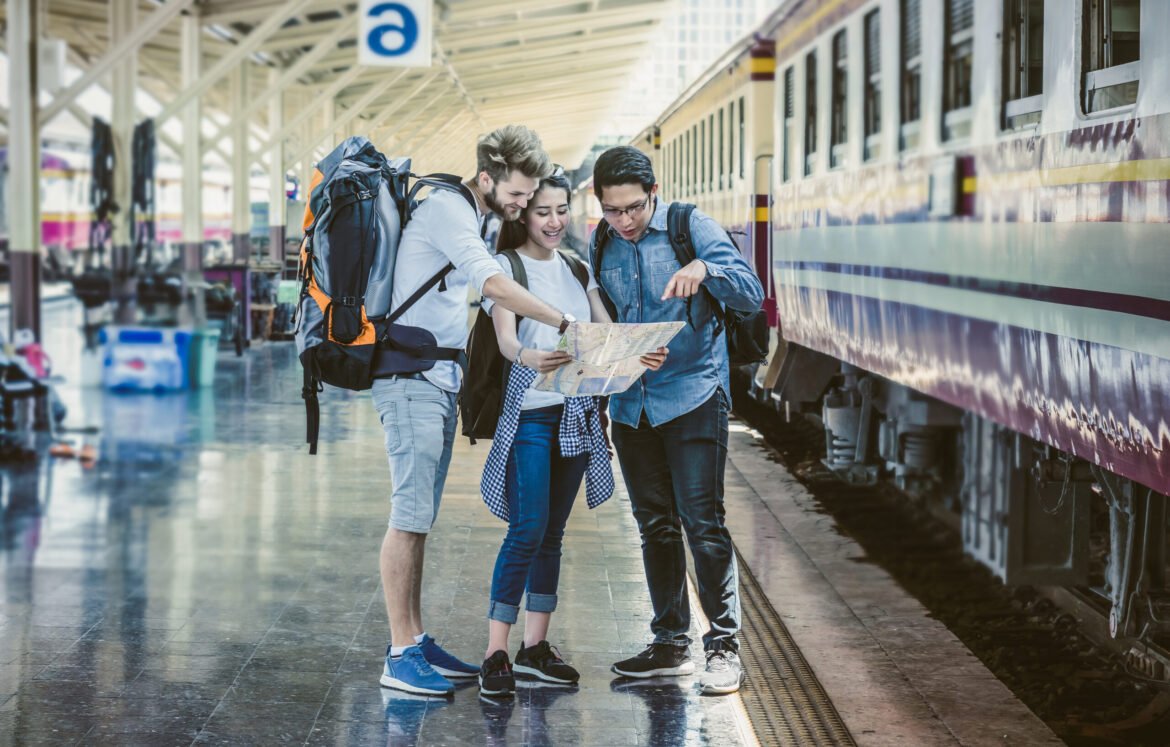 Multiethnic Travellers are looking at the map at the train station, Travel and transportation concept