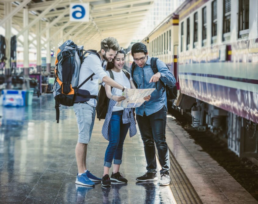 Multiethnic Travellers are looking at the map at the train station, Travel and transportation concept