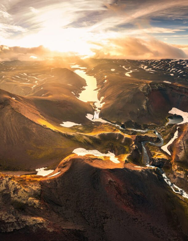 Aerial drone view of sunset over mysterious volcanic crater and glacier stretches through the central highlands of iceland on summer. Rauoibotn, Torfajokull and Myrdalsjokull glaciers