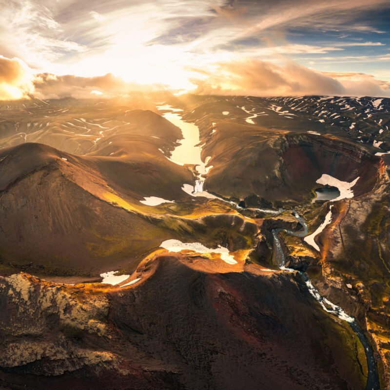 Aerial drone view of sunset over mysterious volcanic crater and glacier stretches through the central highlands of iceland on summer. Rauoibotn, Torfajokull and Myrdalsjokull glaciers