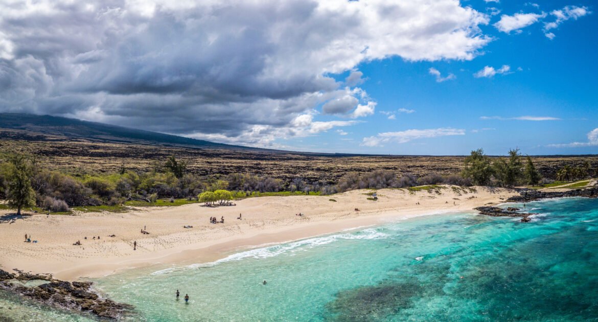 The calm Pacific Ocean and sunny, cloudy shore in Hawaii, USA