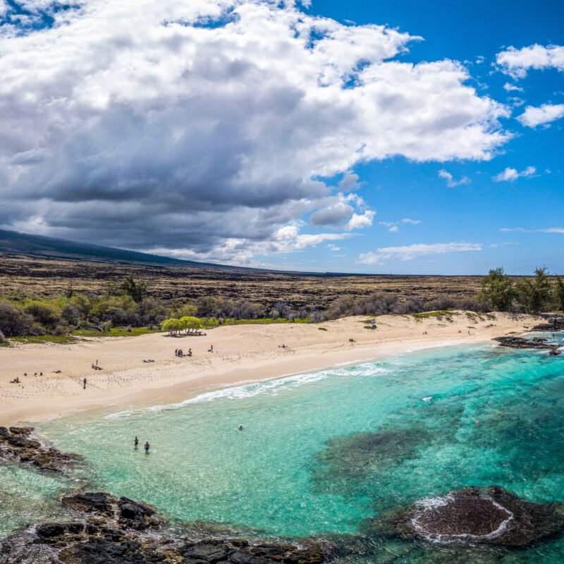The calm Pacific Ocean and sunny, cloudy shore in Hawaii, USA