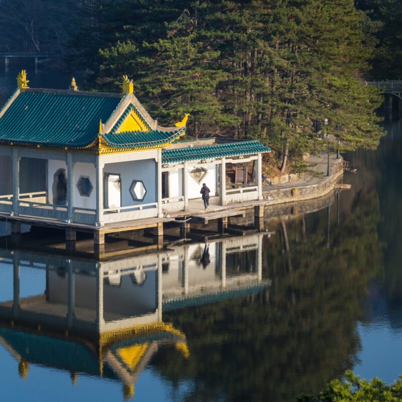 traditional pavilion at dusk on lake, lushan mountain landscape closeup, jiangxi province, China.