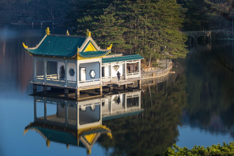 traditional pavilion at dusk on lake, lushan mountain landscape closeup, jiangxi province, China.