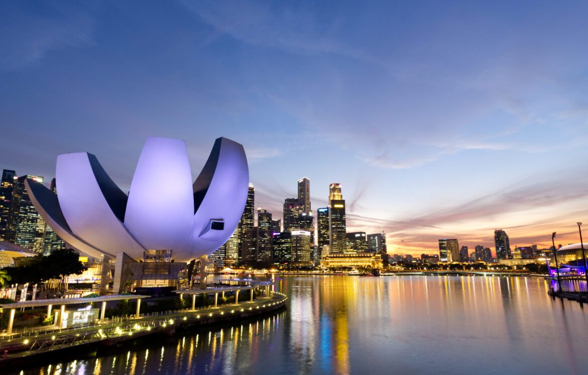 Merlion Park, Marina bay at Singapore - April 3rd,2019; City view and ArtScience Museum at evening twilight from The Helix bridge at Marina bay.