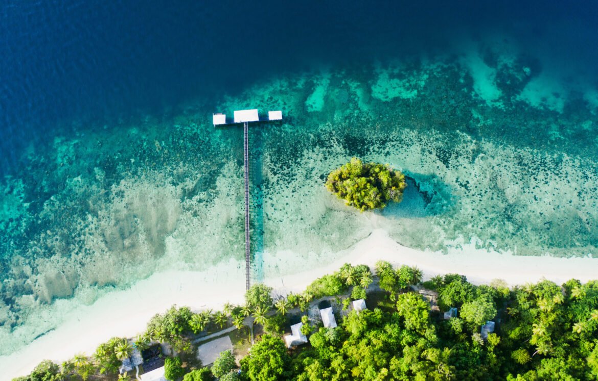 Its quiet on the coast. High angle shot of a clear blue ocean touching the coastline