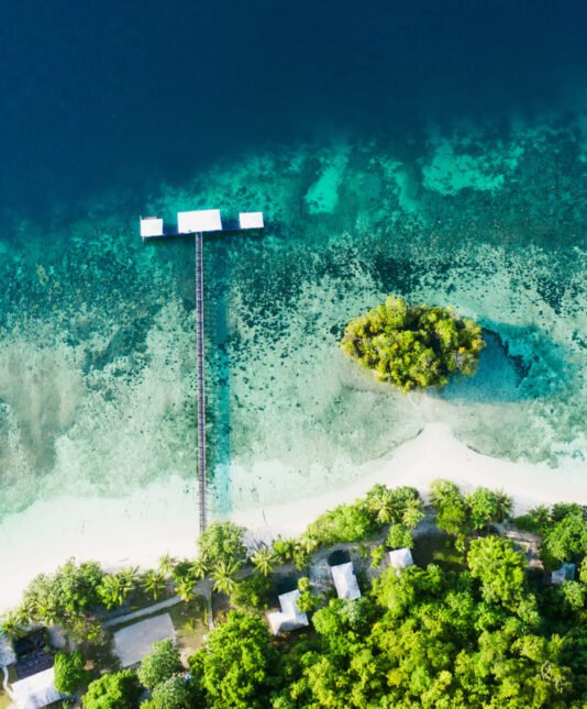 Its quiet on the coast. High angle shot of a clear blue ocean touching the coastline