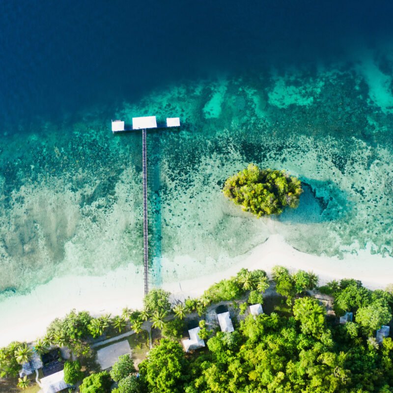 Its quiet on the coast. High angle shot of a clear blue ocean touching the coastline