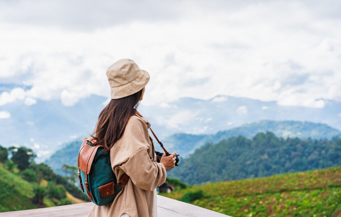 Young woman traveler taking a beautiful landscape at the mountains, Travel lifestyle concept